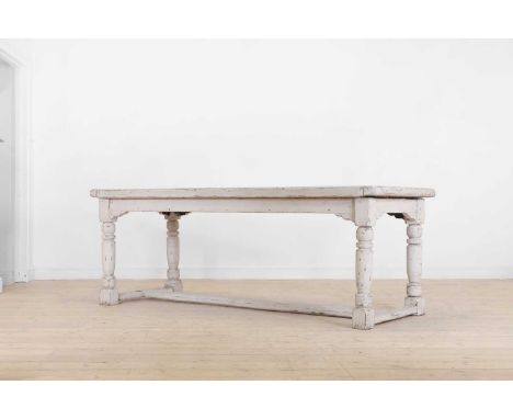 A painted pine refectory table, 20th century, French, the cleated plank top raised on ring-turned supports, united by stretch