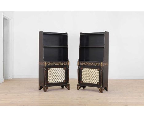 A pair of Regency-style painted and parcel-gilt wooden waterfall bookcases, 20th century, each with a brass grille door flank