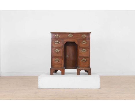 A George III mahogany kneehole desk, c.1760, the moulded rectangular top above a frieze drawer and two pedestals, each fitted