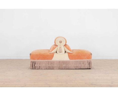A Napoleon III double-sided stool, late 19th century, French, upholstered in peach and off-white chenille with fringing and t
