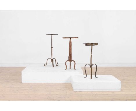 An assembled set of three metal martini tables, 20th century, Continental, each with a scalloped circular top over the stem a