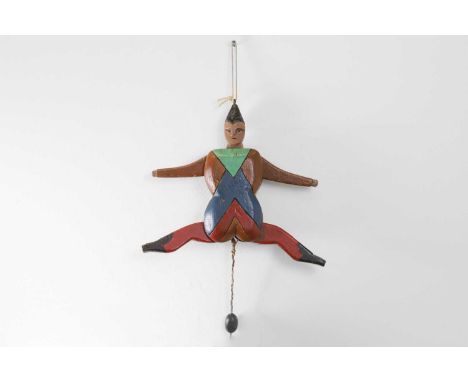 A folk art carved and painted wood 'Jumping Jack', 19th century, painted as a jester with polychrome decoration, the articula
