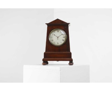 A Regency mahogany mantel clock, the enamelled dial with Roman numerals, slim hands and a watch key winding hole, with a prin