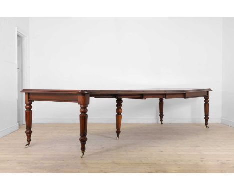 A William IV mahogany extending dining table, c.1840, the top with three additional leaves, raised on lobed supports terminat