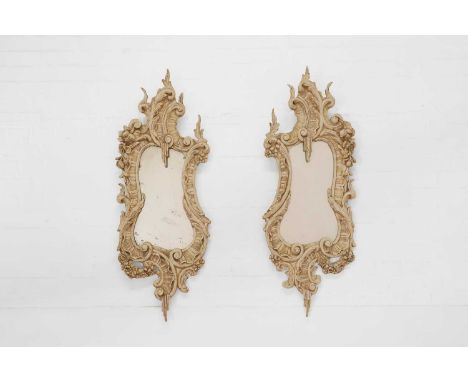 A pair of painted wooden mirrors,  19th century and later, each decorated in the Chippendale rococo taste, the frame carved w