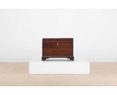 A George III mahogany cellaret, c.1760, the caddy top enclosing a divisioned interior, set with a bone escutcheon and a pair 