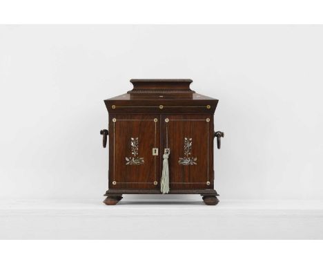 A George IV rosewood and mother-of-pearl inlaid table cabinet, c.1830, the hinged caddy top opening to reveal a tooled leathe
