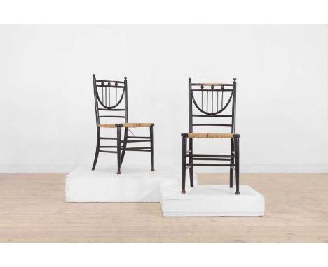 A pair of ebonised wooden side chairs, early 20th century, each with a lyre-form splat and turned supports,43cm wide45cm deep