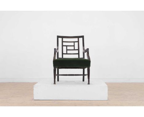 An Aesthetic Period ebonised walnut elbow chair in the manner of E W Godwin, c.1900, with ring-turned supports,59cm wide65cm 