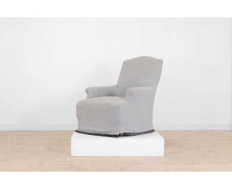 An upholstered armchair by OKA, of recent manufacture, raised on ring-turned supports terminating in castors, with a loose co