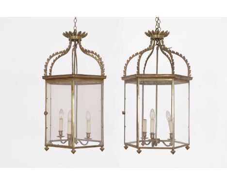 A pair of George III-style brass and glass hall lanterns, 20th century, each of octagonal form with acanthus-cast decoration,