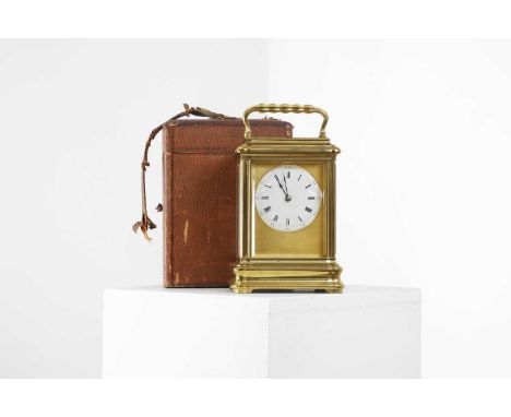 A large brass carriage clock,  c.1860, French, 'no. 5180', a circular enamel dial, enclosing a movement striking the half hou