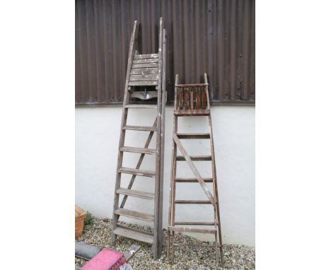 Two sets of tall folding step ladders 