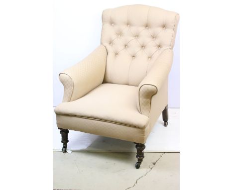 Victorian framed arm chair with later upholstery raised on ceramic castors. the chair having a button back upholstery. Measur