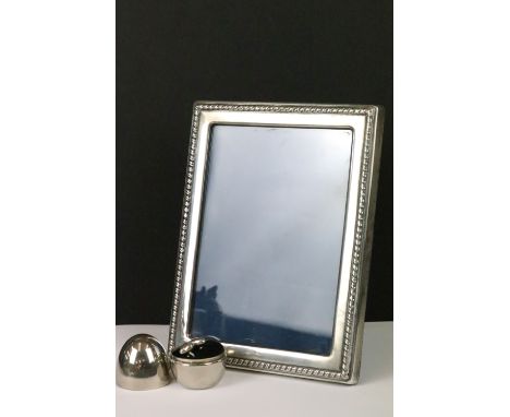 A fully hallmarked sterling silver easel back photograph frame by Robert Carrs of Sheffield together with a pair of silver cu