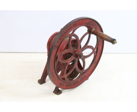 Mid 20th century Uno cast iron coffee grinder on footed base with turning wheel and wooden handle, 'Uno Company Ltd' branding