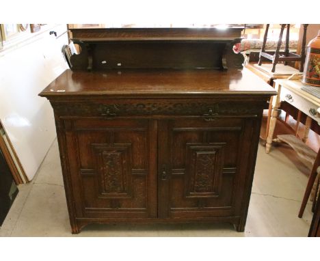 20th century oak sideboard, with galleried shelf back, above carved frieze drawer and a pair of carved panelled doors, 125cm 