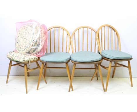 Group of four vintage mid 20th Century light Ercol hoop back dining chairs, raised on turned legs united by H stretchers.