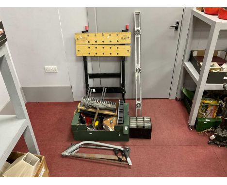Tools to include bow saw, axe, crowbar, spirit level, various screws in organising boxes,p and a wooden and metal workbench.