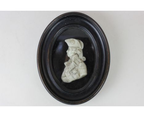 John Flaxman, a 19th century wax profile portrait on glass depicting Lord Nelson, signed, verso inscribed paper label and ano