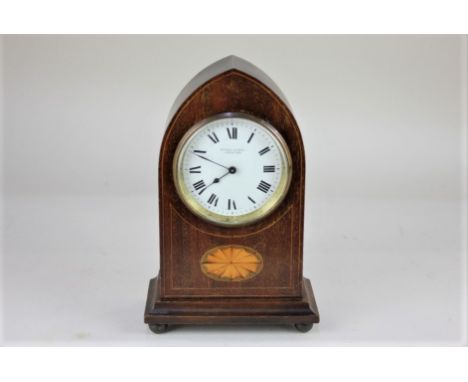 An Edwardian mahogany lancet shaped mantle clock by Kendal &amp; Dent Cheapside, the circular white dial with Roman numerals,