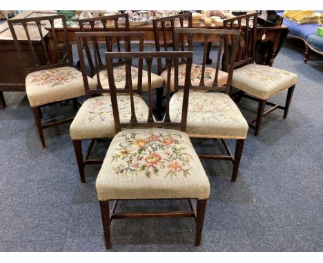 A matched set of seven 19th century mahogany dining chairs with carved floral and fluted bar backs, various tapestry seats on
