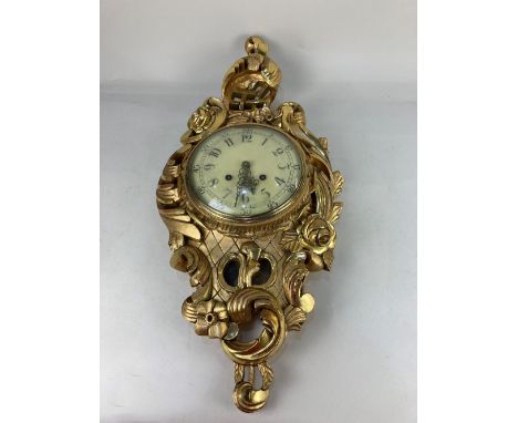 A Rococo style Swedish wall clock, maker Y. Westerstrands, Töreboda marked on movement, striking on a bell, of gilt scrolling