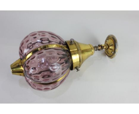 A brass and dimpled pink glass hanging ceiling light fitting, 35cm