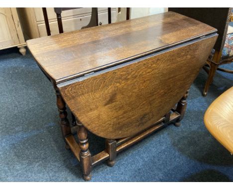 An 18th century oak gate leg dining table on turned and block legs, 142cm open