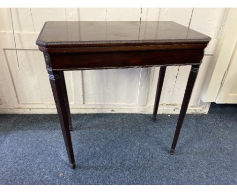 A mahogany rectangular card table with finely carved border and fold over top with green baise lining, on square tapered legs