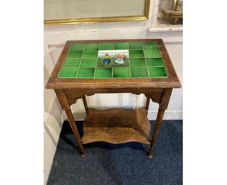 An early 20th century tile topped oak occasional table, rectangular top with green tiles and central tile of Dutch children a