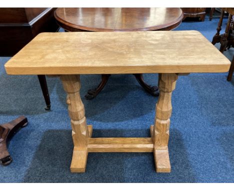 A Robert Mouseman Thompson oak rectangular side table with adzed top on two baluster supports and low stretcher, carved mouse