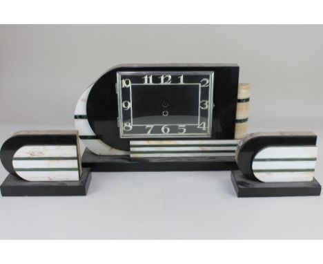 An Art Deco marble three piece clock garniture, possibly French, with green and white striped decoration, clock 25.5cm high (
