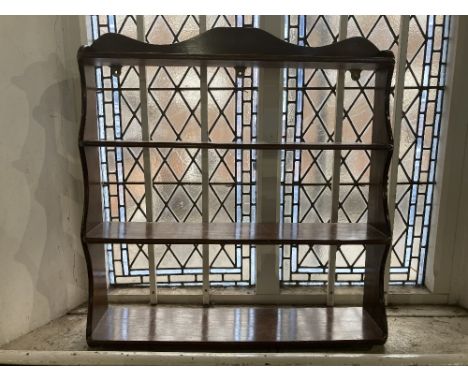 A four shelf oak wall shelf, with shaped top, 77cm