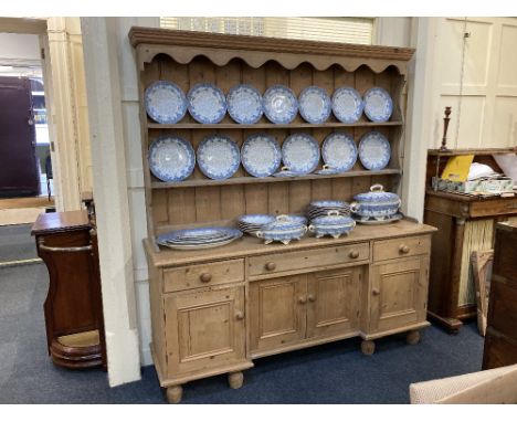 A pine dresser with two shelf back on inverted breakfront base with three drawers and cupboards, 174cm