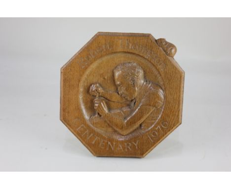 A Robert Mouseman Thompson Oak 1976 Centenary Octagonal Plaque, the centre carved with Robert Thompson carving a mouse, surro