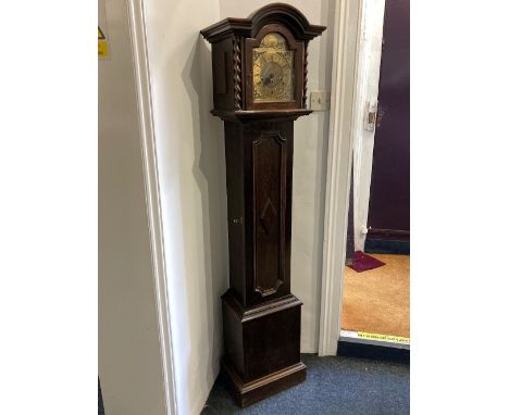 An oak grandmother clock with brass dial in arched case with turned supports and panelled door, 169cm