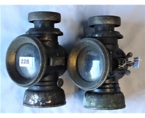A PAIR OF LUCAS F141 OIL LAMPS. In sound condition with component parts insitu, brass bodies with black enamel, in need of re