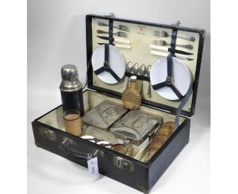 A HARLEQUIN FOUR-PERSON PICNIC CASE.  A suitcase-style set with a full complement of knives, forks, plates, raffia-covered bo