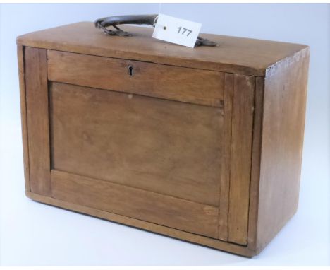 AN ENGINEER'S TOOL BOX. A wooden box with carrying handle and removeable lockable front, opening to reveal four drawers conta