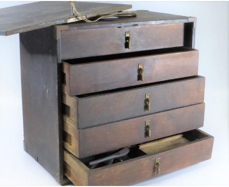 AN ENGINEER'S TOOL BOX.  A wooden box with carrying handle and removeable lockable front, opening to reveal five drawers cont
