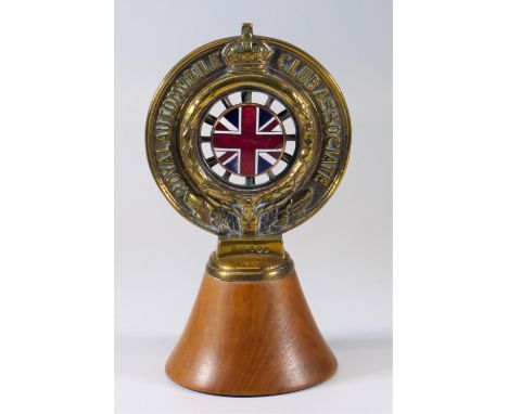 ROYAL AUTOMOBILE CLUB ASSOCIATE'S BADGE.  A brass example with its annual subscription disc aperture and frame, the disc miss