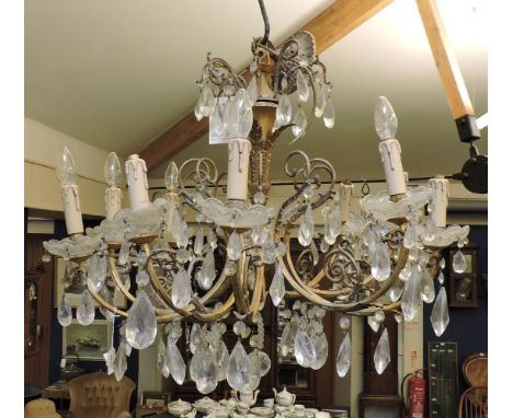 A gilt metal ten branch chandelier of French design, with cast acanthus detail