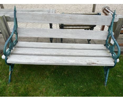 A garden bench, with iron ends and hardwood slatted back and seat. 157cm wide