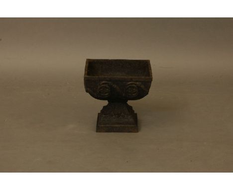 A small cast iron planter, of square form, with rosette decoration, and on square stepped base, 27cm square x 24cm high