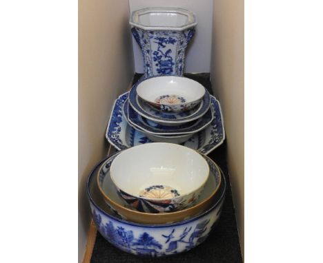 An assortment of Oriental porcelain, including Imari bowls, a blue and white vase, and blue and white platters and bowls