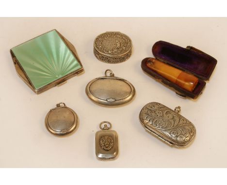 An Art Deco silver and enamelled compact, the green enamelled engine turned lid, opening to reveal mirror and pad within, mar