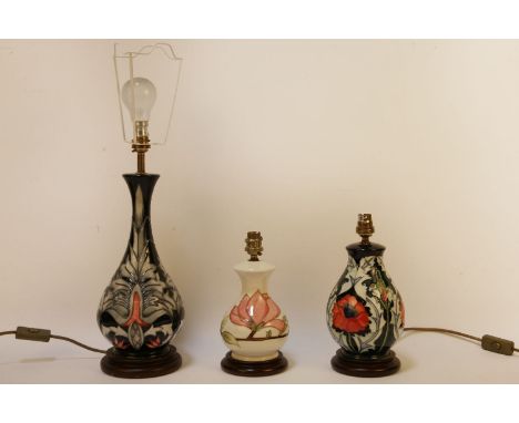 Three Moorcroft lamp bases, one lacking shade, 34cm tallest