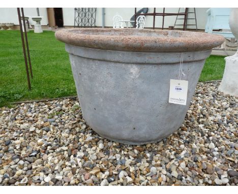 A large circular faux stone planter, 71cm diameter x 46cm high