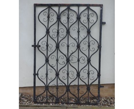 A wrought iron single gate, with pierced scrolling panels, 122 x 174cm